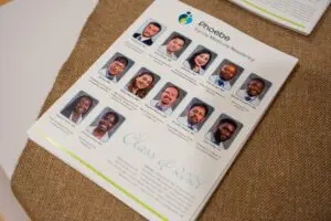 A flyer with headshots of medical residents, Class of 2024, for the Phoebe Family Medicine Residency on burlap cloth.