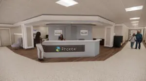 Reception area at Phoebe Putney Memorial Hospital, with organization signage and people near the surgical family waiting hallway.