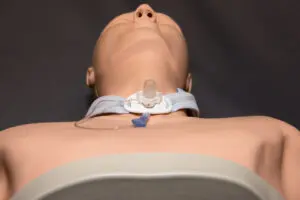 Phoebe Trauma Surgeon Has New Research on Tracheostomy Complications Accepted for Publication 3 Medical mannequin with a tracheostomy tube and neck collar used for trauma surgeon training.